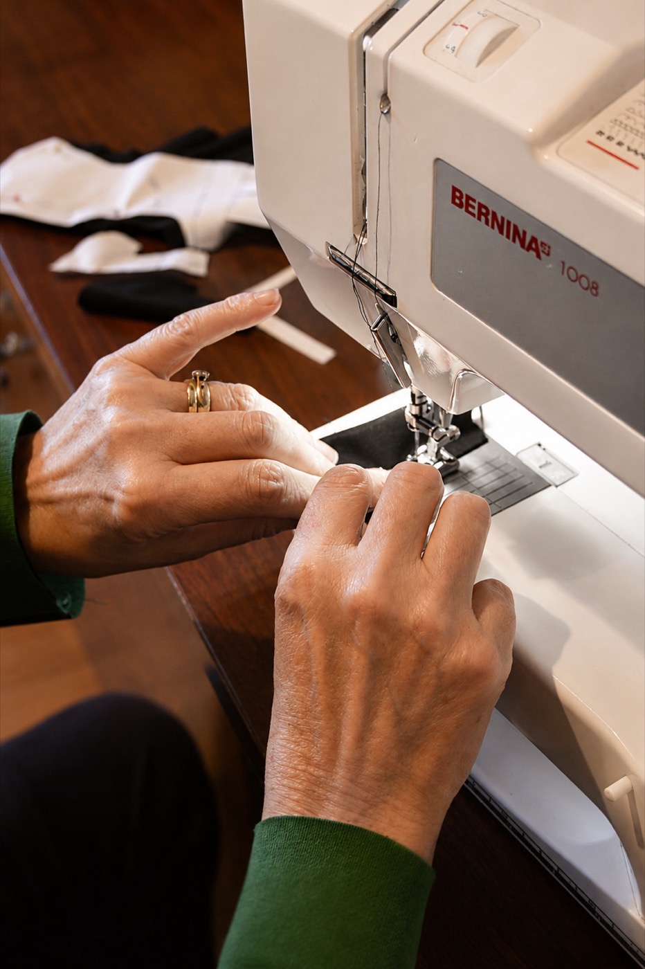 A therapist hand-stitching a custom-made pressure garment